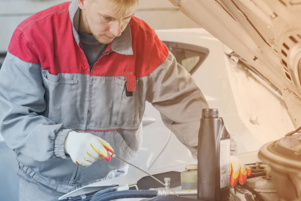 istock Mechanic repairing car with open hood 1001657244