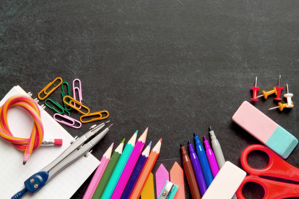 istock School supplies on blackboard background . The concept of education, study, learning, elearning. Back to school 1001657734