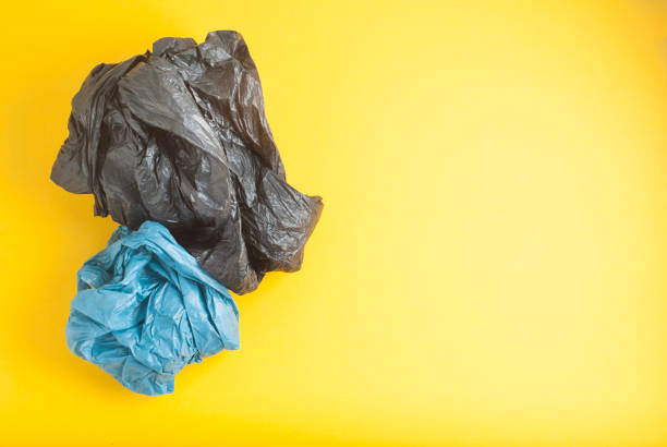 istock Plastic Blue and Black Bags, Yellow Background No Plastic, Recylcle Concept Copy Space 1001660976