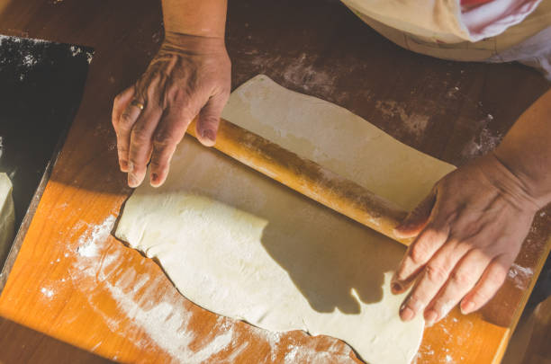 istock the grandmother is preparing pies with Apple jam 1001661104