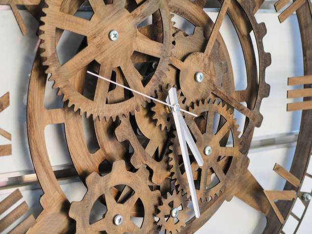 istock timber clock on the wall made of wheel 1001662548