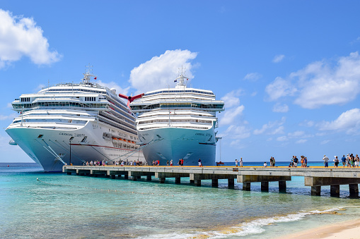 Grand Turk, Turks and Caicos Islands - April 03 2014: Carnival Liberty and Carnival Victory Cruise Ships docked side by side at the Grand Turk Cruise Terminal in the Turks and Caicos Islands.