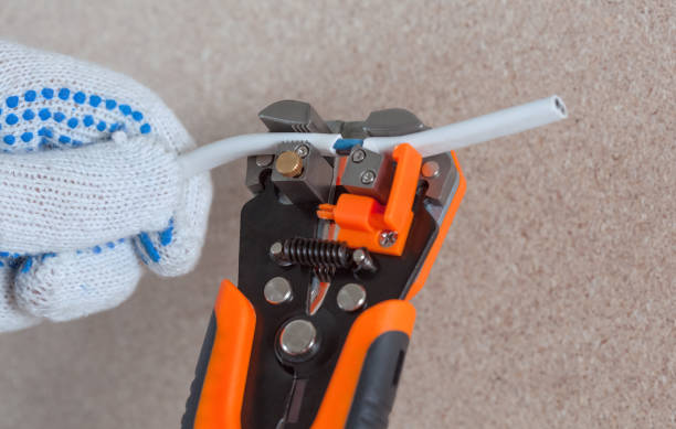 istock The electrician cuts the wire and runs the wiring 1001665408