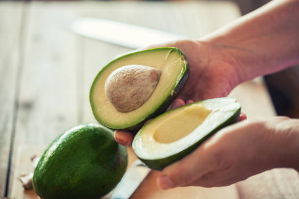 istock Guacamole making, halved avocado close-up 1001666016