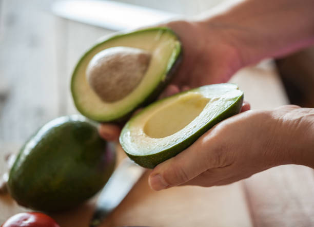 istock Guacamole making, halved avocado close-up 1001668320
