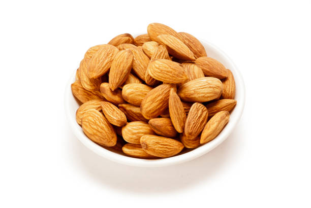 istock Almonds in glass bowl isolated on white background 1001668520