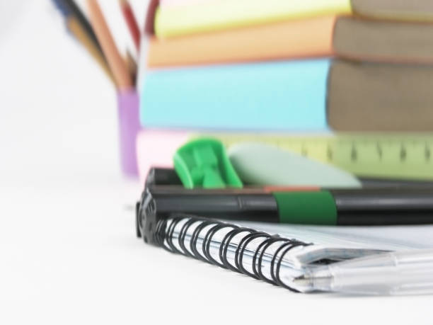 istock close up.white ball point pen on the notebook .photo with copy space 1001668532
