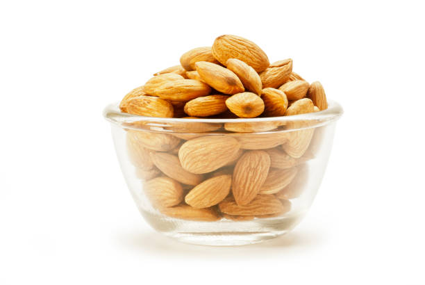 istock Almonds in glass bowl isolated on white background 1001668882