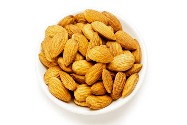 istock Almonds in glass bowl isolated on white background 1001668886