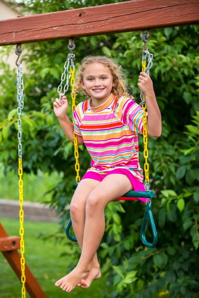 istock Young Girl Using Trapeze Bar as Swing 1001672314