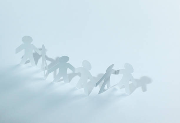 istock group of paper men holding each other's hands 1001672944