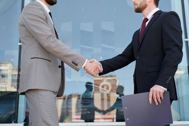 istock Men shaking hands outdoors 1001677494