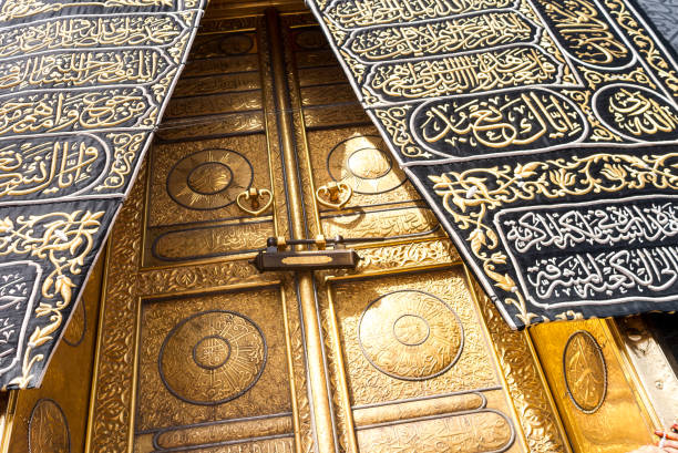 The golden doors of Holy Kaaba MECCA, SAUDI ARABIA: The golden doors of the Holy Kaaba closeup, covered with Kiswah. Massive lock on the doors. Entrance to the Kaaba in Masjid al Haram grand mosque photos stock pictures, royalty-free photos & images