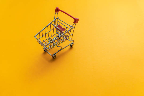 istock Shopping cart yellow background 1001677772