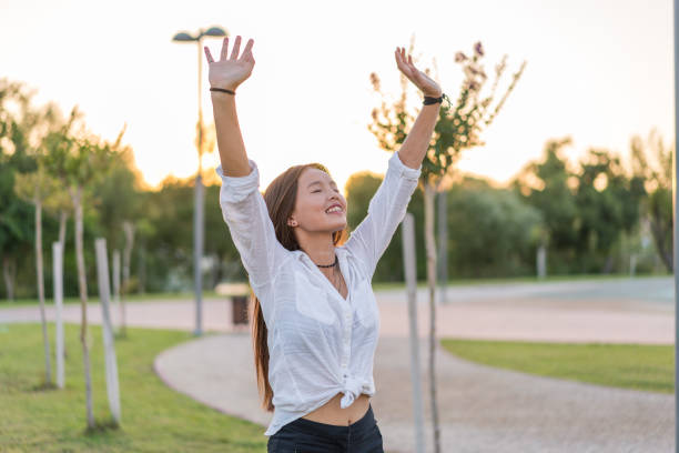 istock Young asian women relaxing at grass in park 1001680388