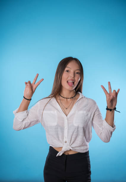 istock Young asian woman facial expression over colored background 1001684528