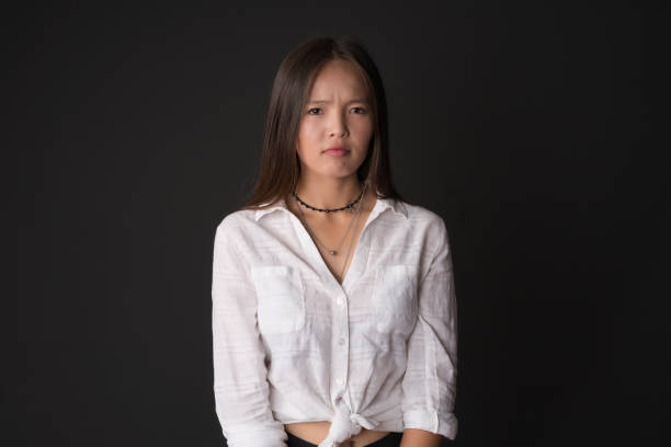 istock Young asian woman facial expression over black background 1001688178