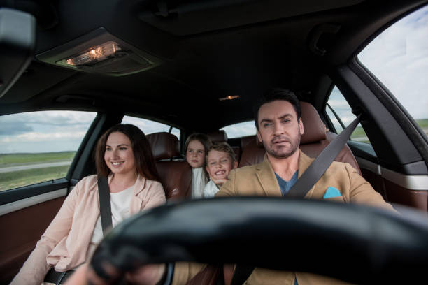 istock father fastens his seat belt sitting in the car 1001699120