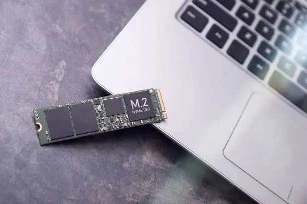 Fast M.2 Solid State Drive lies on a modern aluminum laptop