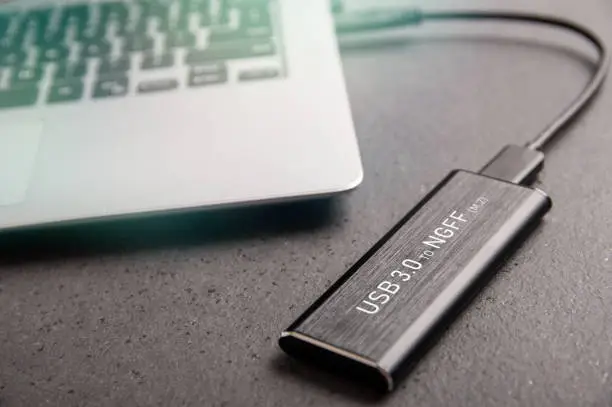 Adapter from the M.2 SSD to USB 3.0 is connected to a modern laptop
