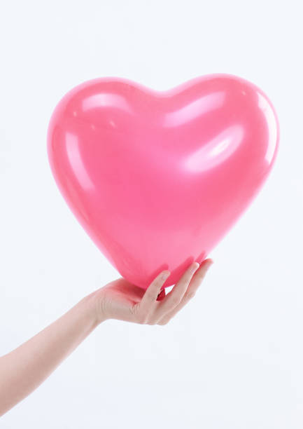 istock Young woman holding a big red heart.isolated on white 1001709286