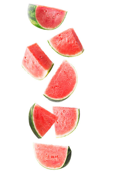 istock Sliced red falling watermelon isolated on white background with clipping path as package design element and advertising. Floating fruits in the air 1001712514