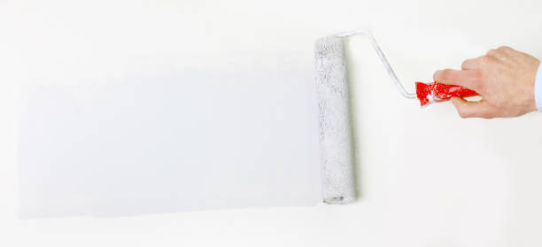 istock closeup.businessman drawing a paint roller on the wall 1001718486