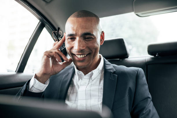 istock Businessman using laptop sitting in car 1001718792