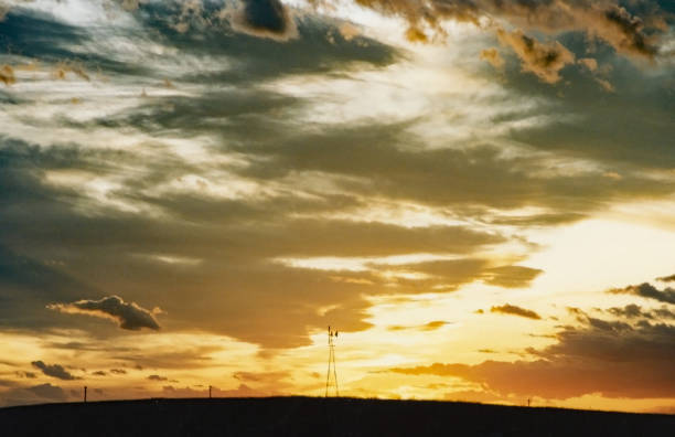 istock Autumn prairie sky with wind mill 1001718836