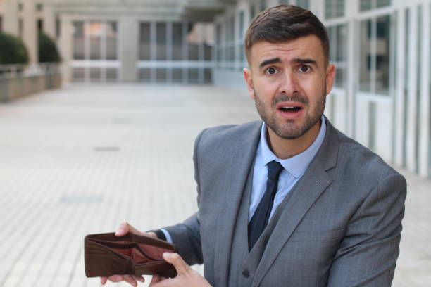istock Broke businessman showing his empty wallet 1001719044