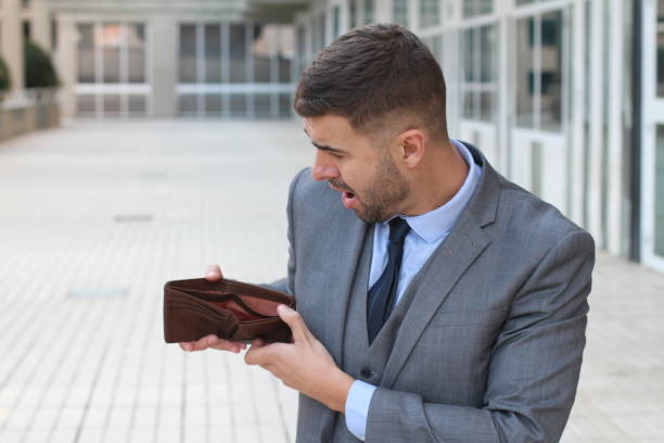 istock Broke businessman showing his empty wallet 1001719054