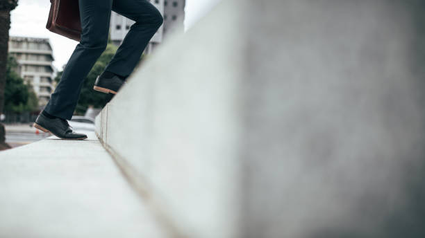istock Man walking up the stairs 1001719172