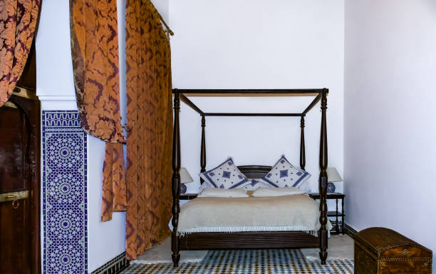 traditional moroccan bedroom with a canopy bed and mosaic in a riad in fes - pillow cushion embroidery homewares imagens e fotografias de stock