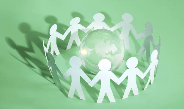 istock group of paper men standing around the glass globe 1001730818
