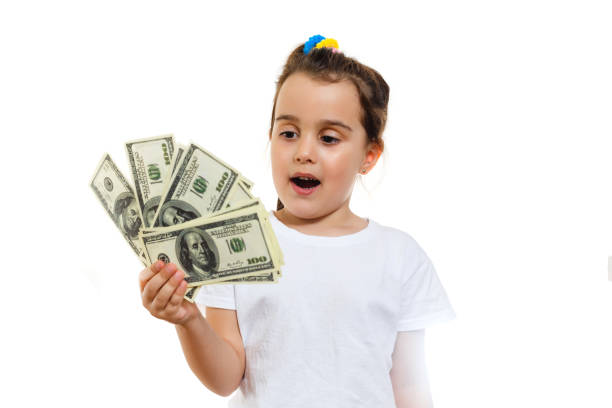 istock Happy child with money dollar isolated on a white background 1001732050