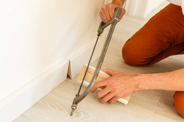 istock Installing the new skirting board after changing the parquet 1001738192