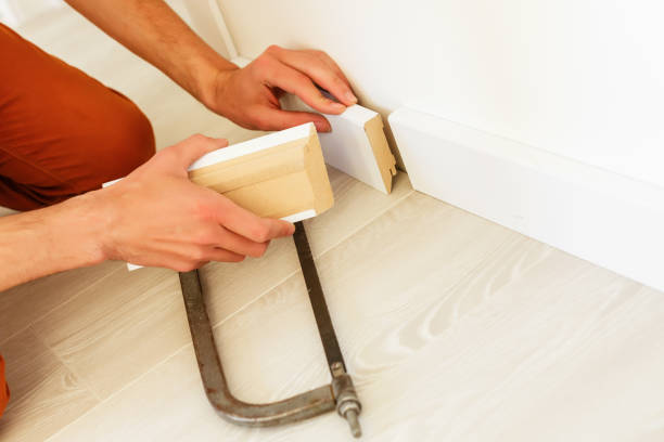 istock Installing the new skirting board after changing the parquet 1001738252