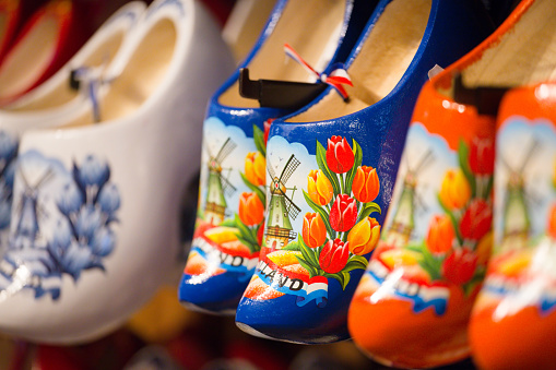 lot of multicolored souvenir Dutch wooden shoes klomp in the shop\