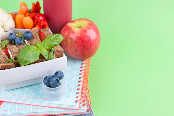 istock School lunch in a box and juice with fruit on a green background. Free space for text. Copy space 1001738604