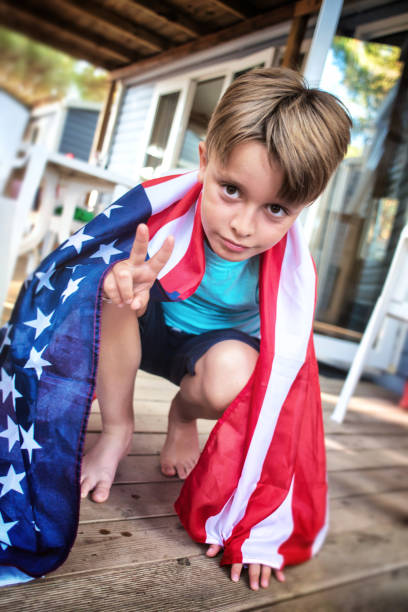 istock Child Wrapped in an American Flag 1001739492