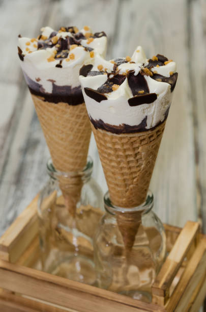 istock Ice cream cornetto.  Ice cream waffle cone vanilla and chocolate on rustic background 1001742186