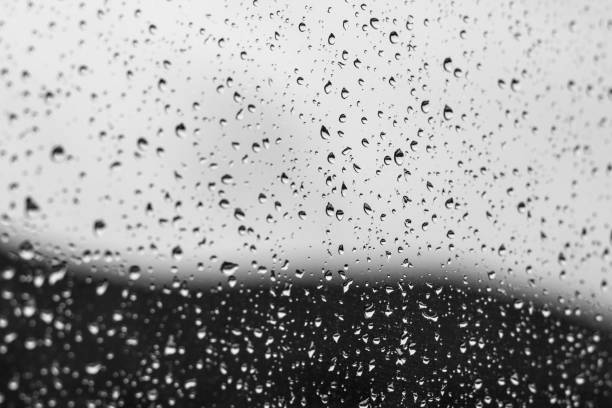 istock Water drops on glass with blurred mountain on the background 1001750406