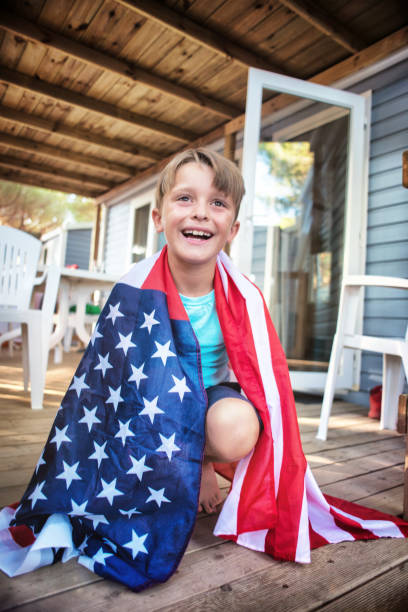 istock Child Wrapped in an American Flag 1001751010