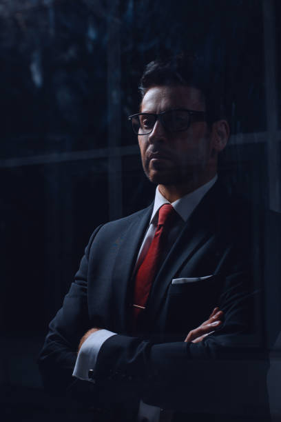 istock close up.businessman standing in a dark office 1001753798