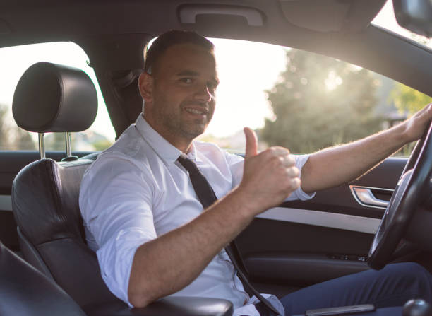istock Businessman in a car with a raised thumbs up 1001753872