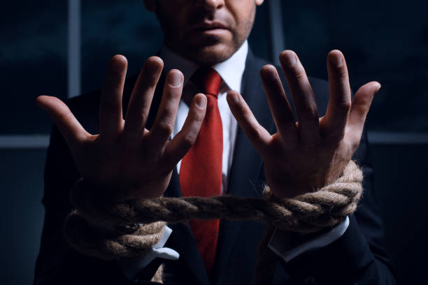 istock Businessman with hands tied in ropes 1001754502