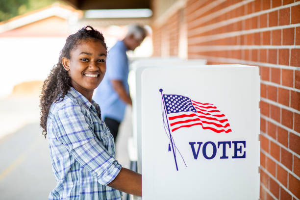 Beautiful Young Black Girl Voting A young black girl voting on election day voting rights stock pictures, royalty-free photos & images