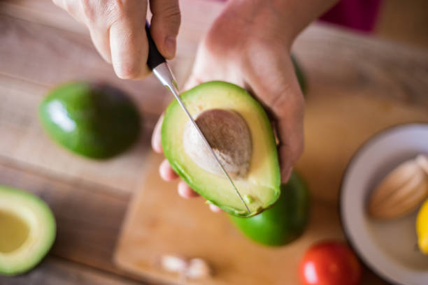 istock Guacamole making, halved avocado close-up 1001770498