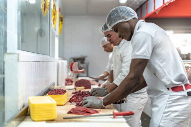 Group of people working at the butchery Team work meat packing industry photos stock pictures, royalty-free photos & images