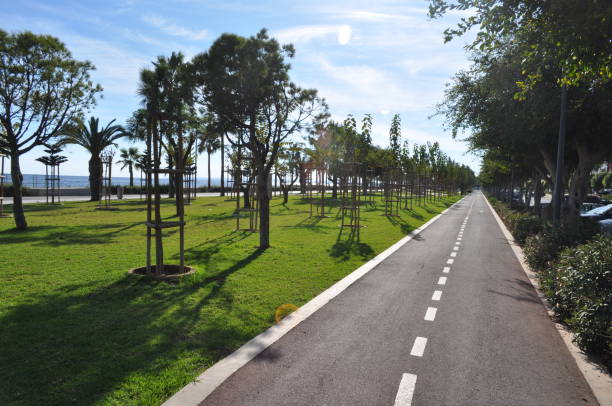 Tourist on a bike on a path of the seafront of Arcachon on a summer day in France